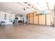 Spacious garage featuring epoxy flooring, built-in storage cabinets, and ample workspace for hobbies at 16772 W Cypress St, Goodyear, AZ 85395