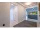 Clean, neutral hallway leads into a bright living area with a view to the outside at 16772 W Cypress St, Goodyear, AZ 85395