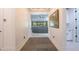 Bright hallway leads into an open living area with modern decor and neutral color palette at 16772 W Cypress St, Goodyear, AZ 85395