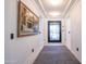 Elegant hallway featuring tiled floors, crown molding, and an artful painting near the entryway at 16772 W Cypress St, Goodyear, AZ 85395