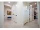 Bright hallway with tiled floors, white walls, and access to walk-in closet at 16772 W Cypress St, Goodyear, AZ 85395