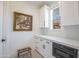 Well-lit kitchen area featuring white cabinetry, built-in microwave, and an adorable pet feeding station at 16772 W Cypress St, Goodyear, AZ 85395