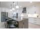 Updated kitchen with white cabinets, black hardware, and island with bar seating at 16772 W Cypress St, Goodyear, AZ 85395
