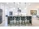The kitchen features a large island with bar seating, stainless appliances, and white cabinetry at 16772 W Cypress St, Goodyear, AZ 85395