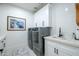 Well-equipped laundry room with modern washer/dryer units, white cabinets, and a stylish sink area at 16772 W Cypress St, Goodyear, AZ 85395