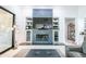 Living room showcasing a stylish fireplace with built-in shelving and tiled floors at 16772 W Cypress St, Goodyear, AZ 85395