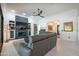 Bright living room features fireplace, built-in shelving and a view into the open-concept home at 16772 W Cypress St, Goodyear, AZ 85395