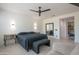 Beautifully staged bedroom featuring neutral tones, tiled floors, and modern ceiling fan at 16772 W Cypress St, Goodyear, AZ 85395