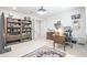Comfortable office featuring a large desk, ample bookshelves, and stylish decor, creating a functional workspace at 16772 W Cypress St, Goodyear, AZ 85395