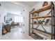 Bright office space with open doorway and a rustic shelving unit featuring wooden shelves with a metal frame at 16772 W Cypress St, Goodyear, AZ 85395