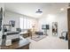 Well-lit office with white tile, shutters, and a wooden desk, creating a serene and productive atmosphere at 16772 W Cypress St, Goodyear, AZ 85395