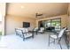 Covered patio showcases comfortable lounge furniture, a ceiling fan, and open views for seamless outdoor enjoyment at 16772 W Cypress St, Goodyear, AZ 85395