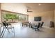 Inviting covered patio boasts comfortable seating, ceiling fan, and seamless indoor-outdoor flow for relaxing and entertaining at 16772 W Cypress St, Goodyear, AZ 85395