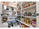 Organized pantry with ample shelving, providing plenty of storage for food and kitchen essentials at 16772 W Cypress St, Goodyear, AZ 85395