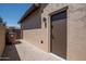 Side yard with paver stones leading to a secure access door at 16772 W Cypress St, Goodyear, AZ 85395