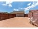 Desert backyard with a white patio furniture set at 1680 E Cardinal Dr, Casa Grande, AZ 85122