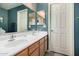 This bathroom features double sinks and a large mirror, with a white door and blue painted walls at 1680 E Cardinal Dr, Casa Grande, AZ 85122