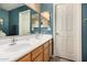 Well-lit bathroom featuring a double sink vanity with wood cabinetry and neutral countertops at 1680 E Cardinal Dr, Casa Grande, AZ 85122