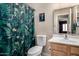 Bathroom featuring a floral shower curtain, a toilet, a wall mirror, and wood-look vanity at 1680 E Cardinal Dr, Casa Grande, AZ 85122