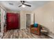 Brightly-lit room with wood-look floors featuring red armoire and a brown leather sitting chair at 1680 E Cardinal Dr, Casa Grande, AZ 85122