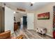 Bedroom featuring wood-look floors and open door leading to living area; brightly lit and spacious at 1680 E Cardinal Dr, Casa Grande, AZ 85122