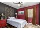 Cozy bedroom featuring a ceiling fan, a painting hanging above the bed, and a warm color palette at 1680 E Cardinal Dr, Casa Grande, AZ 85122