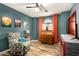 Bedroom featuring wood floors, a ceiling fan, and a comfortable patterned armchair at 1680 E Cardinal Dr, Casa Grande, AZ 85122