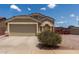 Charming single-story home features a two car garage and inviting curb appeal with desert landscaping and a blue sky backdrop at 1680 E Cardinal Dr, Casa Grande, AZ 85122