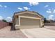 Spacious two-car garage with a wide driveway and neutral paint scheme at 1680 E Cardinal Dr, Casa Grande, AZ 85122