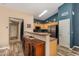 Modern kitchen with stainless steel appliances, light wood cabinets, and a serving counter to the dining area at 1680 E Cardinal Dr, Casa Grande, AZ 85122
