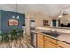 Bright kitchen with stainless steel appliances and a dining area with a wood table and green chairs at 1680 E Cardinal Dr, Casa Grande, AZ 85122