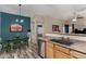 Open concept kitchen with a breakfast bar, stainless steel dishwasher and a dining area with green table and chairs at 1680 E Cardinal Dr, Casa Grande, AZ 85122