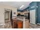 Eat-in kitchen features stainless steel appliances, maple cabinets, and open sight lines to the living areas with wood-look floors at 1680 E Cardinal Dr, Casa Grande, AZ 85122