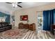 Cozy living room with wood-look flooring, neutral paint, lots of seating, and a sliding glass door leading to outdoor living at 1680 E Cardinal Dr, Casa Grande, AZ 85122