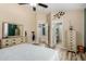Bright main bedroom featuring a ceiling fan and adjacent bathroom entrance for convenient access at 1680 E Cardinal Dr, Casa Grande, AZ 85122