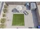 Aerial view of backyard with turf area, patio set, playset, and desert landscaping at 1769 E Jacob St, San Tan Valley, AZ 85140