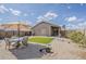 Well-maintained backyard featuring a patio set, green turf, and desert landscaping at 1769 E Jacob St, San Tan Valley, AZ 85140
