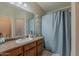 Bathroom with an undermount sink, warm vanity, and framed mirror at 1769 E Jacob St, San Tan Valley, AZ 85140