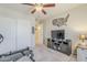 Bedroom with an accent wall, exercise equipment, and modern media console at 1769 E Jacob St, San Tan Valley, AZ 85140