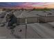 Charming single-story home with a well-manicured desert landscape, tile roof, and two-car garage at sunset at 1769 E Jacob St, San Tan Valley, AZ 85140