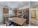 Well-equipped kitchen with stainless steel appliances, wood cabinets, and a kitchen island with seating at 1769 E Jacob St, San Tan Valley, AZ 85140