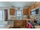 Cozy kitchen with stainless steel appliances, wooden cabinets, tile backsplash and a window overlooking the yard at 1769 E Jacob St, San Tan Valley, AZ 85140