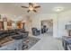 Cozy living room with carpet flooring, a ceiling fan, and an open layout connecting to the kitchen at 1769 E Jacob St, San Tan Valley, AZ 85140