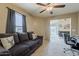 Inviting living room with plush sofa, neutral tones, and easy access to an outdoor space at 1769 E Jacob St, San Tan Valley, AZ 85140