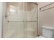 Bathroom featuring a shower with glass doors, a towel rack, and a white toilet at 205 N 74Th St # 166, Mesa, AZ 85207