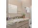 Bathroom vanity with granite countertop, chrome faucet, framed mirror, and neutral color palette at 205 N 74Th St # 166, Mesa, AZ 85207