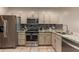 This kitchen features stainless steel appliances, tile backsplash, granite countertops, and light cabinetry at 205 N 74Th St # 166, Mesa, AZ 85207