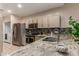 This kitchen features stainless steel appliances, granite countertops, tile backsplash, and light wooden cabinets at 205 N 74Th St # 166, Mesa, AZ 85207
