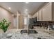This kitchen features granite countertops, tile backsplash, stainless steel appliances, and light cabinetry at 205 N 74Th St # 166, Mesa, AZ 85207