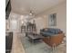 Open-concept living room and kitchen with bar seating, tile floors, and comfortable modern furniture at 205 N 74Th St # 166, Mesa, AZ 85207